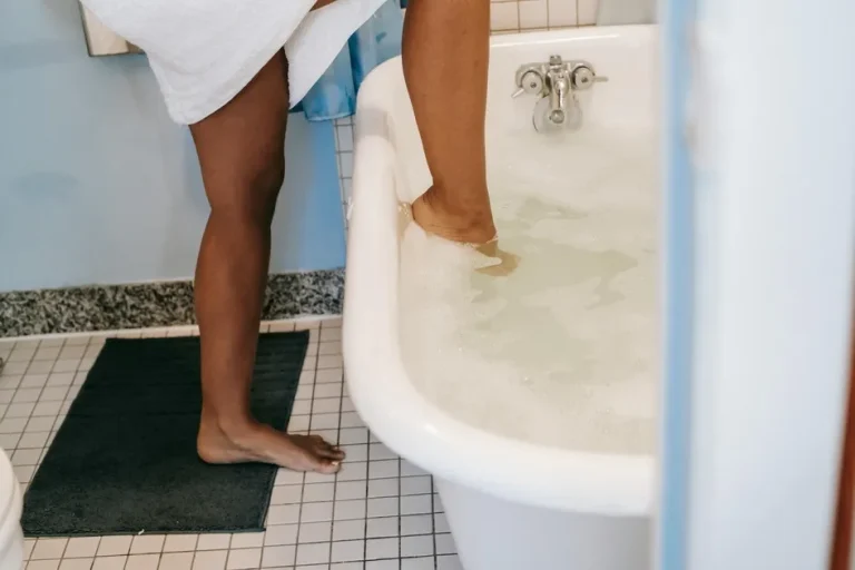 Woman's foot stepping into a bath