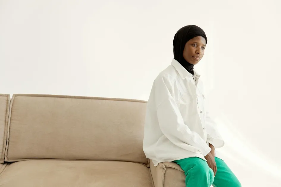 Woman sitting on a beige couch