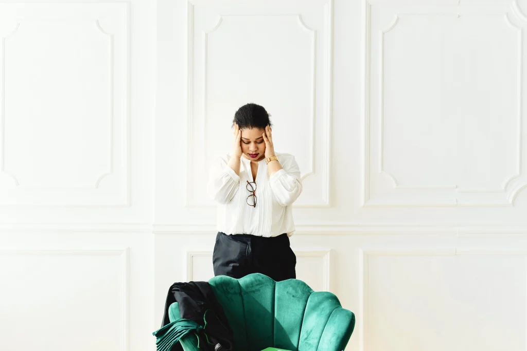 Can you have ADHD without hyperactivity? A woman holding her head, illustrating the internal "mental noise" of inattentive ADHD.
