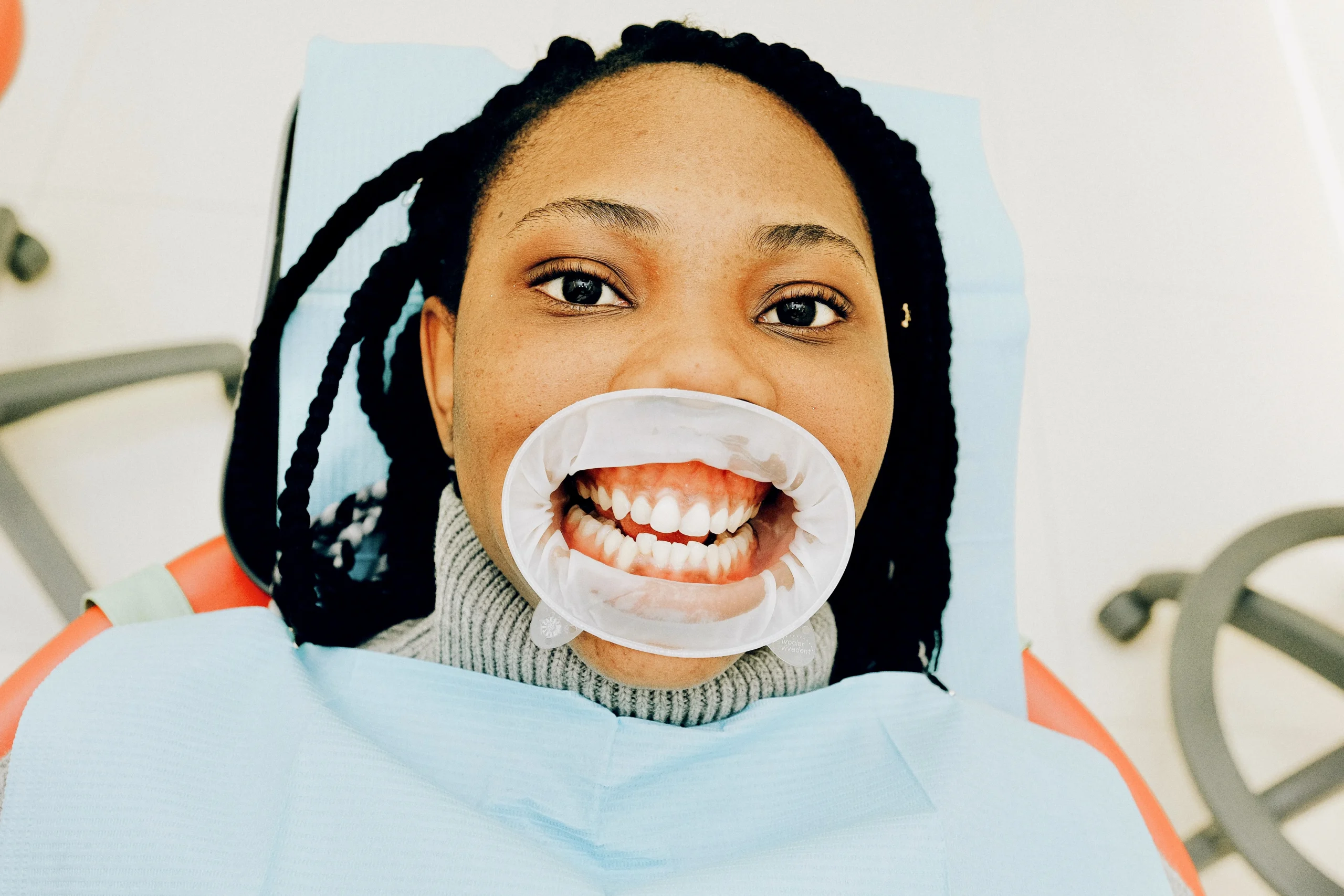 Woman at the dentist getting a look at her teeth asking: Why do I hate brushing my teeth?